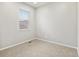 Bright and airy bedroom with neutral carpet, a large window with blinds, and light gray walls at 559 Homestead Ave, Brighton, CO 80601