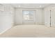 A bright bedroom with plush carpet, large window and an entry doorway, providing a relaxing retreat at 559 Homestead Ave, Brighton, CO 80601