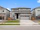 Charming two-story home with a stone facade, a well-manicured lawn, and an attached two-car garage at 559 Homestead Ave, Brighton, CO 80601