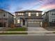 Stunning two-story home with a stone facade and a spacious two-car garage, set against a colorful sky at 559 Homestead Ave, Brighton, CO 80601