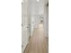Clean, light-filled hallway with wood floors leading to a stairway and a sliding glass door at 559 Homestead Ave, Brighton, CO 80601