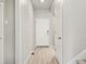 Bright hallway with wood floors, white doors, and access to the stairway, creating a clean and inviting space at 559 Homestead Ave, Brighton, CO 80601