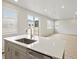 Open floor plan featuring kitchen island with sink and eat in bar at 559 Homestead Ave, Brighton, CO 80601