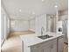 Open kitchen features an island, stainless steel appliances, and wood flooring at 559 Homestead Ave, Brighton, CO 80601