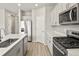 Kitchen with stainless appliances, island, gas range, and wood flooring at 559 Homestead Ave, Brighton, CO 80601
