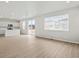 Open floor plan featuring kitchen and living room with wood flooring at 559 Homestead Ave, Brighton, CO 80601