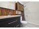 This bathroom features a modern vanity with a stone countertop and a shower/tub combination at 1830 Newland Ct # 101, Lakewood, CO 80214