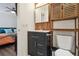 Updated bathroom vanity with modern fixtures and a view into the main bedroom at 1830 Newland Ct # 101, Lakewood, CO 80214