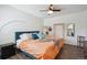 Bright bedroom featuring dark flooring, ceiling fan, and comfortable furnishings at 1830 Newland Ct # 101, Lakewood, CO 80214