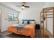 Bright bedroom featuring ceiling fan, closet, and a view of the neighborhood at 1830 Newland Ct # 101, Lakewood, CO 80214