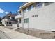 A residential exterior featuring the unit number and low maintenance landscaping and an inviting front porch at 1830 Newland Ct # 101, Lakewood, CO 80214