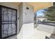 Inviting entryway featuring a secure black door with decorative metalwork and a well-lit covered porch area at 1830 Newland Ct # 101, Lakewood, CO 80214
