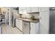 Well-lit kitchen featuring stainless steel appliances and modern white cabinetry at 1830 Newland Ct # 101, Lakewood, CO 80214