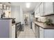 Compact kitchen with stainless steel appliances, and access to the laundry room and other rooms at 1830 Newland Ct # 101, Lakewood, CO 80214