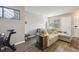 Bright and airy living room featuring hardwood floors, a comfortable couch, and a large window with lots of natural light at 1830 Newland Ct # 101, Lakewood, CO 80214