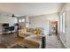 Bright living room featuring hardwood floors, a ceiling fan, and a comfortable couch with colorful throw pillows at 1830 Newland Ct # 101, Lakewood, CO 80214
