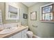 Charming bathroom with a classic vanity, decorative mirror, and soft, neutral wall color at 6565 Marshmerry Ln, Evergreen, CO 80439