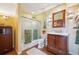 Bathroom features a vanity, mirror, toilet, and a shower with frosted glass and decorative sconces at 6565 Marshmerry Ln, Evergreen, CO 80439