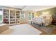 Spacious bedroom featuring built-in bookshelves, outdoor access, and a cozy sitting area at 6565 Marshmerry Ln, Evergreen, CO 80439