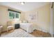Cozy bedroom featuring a comfortable bed, natural light, and a soft area rug at 6565 Marshmerry Ln, Evergreen, CO 80439