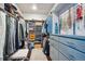 Spacious walk-in closet with custom shelving and storage at 6565 Marshmerry Ln, Evergreen, CO 80439