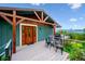 Expansive deck with stunning views, outdoor seating, and elegant wood and metal details at 6565 Marshmerry Ln, Evergreen, CO 80439