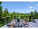 Outdoor deck featuring a table and seating with mountain views at 6565 Marshmerry Ln, Evergreen, CO 80439