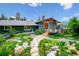 Inviting home exterior featuring a spacious deck, landscaped yard, and stone walkway at 6565 Marshmerry Ln, Evergreen, CO 80439