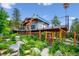 Back of house with large deck, wood and stone landscaping, and beautiful views at 6565 Marshmerry Ln, Evergreen, CO 80439