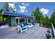 Spacious deck with blue awning and forest views at 6565 Marshmerry Ln, Evergreen, CO 80439