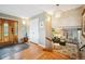 Bright foyer with hardwood floors, coat closet, view of the living room and chandelier at 6565 Marshmerry Ln, Evergreen, CO 80439