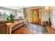 Elegant foyer with hardwood floors, a decorative front door, and a cozy fireplace at 6565 Marshmerry Ln, Evergreen, CO 80439