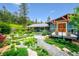 Charming home with lush landscaping, stone pathways, and a welcoming porch, perfect for enjoying the outdoors at 6565 Marshmerry Ln, Evergreen, CO 80439