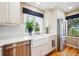 Bright kitchen with stainless steel appliances, farmhouse sink, and scenic views at 6565 Marshmerry Ln, Evergreen, CO 80439