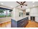 Updated kitchen with marble countertops, blue island, and views of the surrounding mountains at 6565 Marshmerry Ln, Evergreen, CO 80439