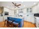 This bright kitchen includes a blue island with seating and stainless appliances at 6565 Marshmerry Ln, Evergreen, CO 80439
