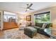 Comfortable living room with sofa, chairs, and a large window with scenic outdoor views at 6565 Marshmerry Ln, Evergreen, CO 80439