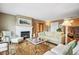 Cozy living room with a fireplace, plush seating, and elegant decor on a patterned rug at 6565 Marshmerry Ln, Evergreen, CO 80439