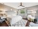 Relaxing primary bedroom with mountain view, hardwood floors and sitting area at 6565 Marshmerry Ln, Evergreen, CO 80439