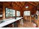 A rustic potting shed features ample natural light, a functional sink, and space for nurturing plants and pursuing gardening projects at 6565 Marshmerry Ln, Evergreen, CO 80439