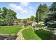 Lush backyard with a stone pathway leading to a cozy fire pit area at 470 S Queen St, Lakewood, CO 80226