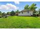 Spacious backyard featuring lush lawn and a charming patio area at 470 S Queen St, Lakewood, CO 80226