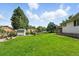 Well-manicured backyard with mature trees and a storage shed at 470 S Queen St, Lakewood, CO 80226