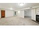 Unfurnished basement with neutral carpeting, access to a fireplace, and open layout for customization at 470 S Queen St, Lakewood, CO 80226