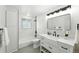 Bright bathroom with tub, modern vanity, and fixtures at 470 S Queen St, Lakewood, CO 80226