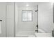 Bright bathroom with tub and tiled walls at 470 S Queen St, Lakewood, CO 80226