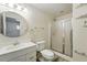 Bathroom featuring a shower, toilet, and sink at 470 S Queen St, Lakewood, CO 80226