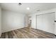 Bright bedroom featuring wood-look floors and a double-door closet at 470 S Queen St, Lakewood, CO 80226