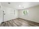Bright bedroom with stylish flooring, minimalist decor, and natural light from the window, creating a peaceful retreat at 470 S Queen St, Lakewood, CO 80226