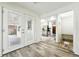 Inviting entryway features wood-look floors, leading to a bright kitchen and outdoor access through glass doors at 470 S Queen St, Lakewood, CO 80226